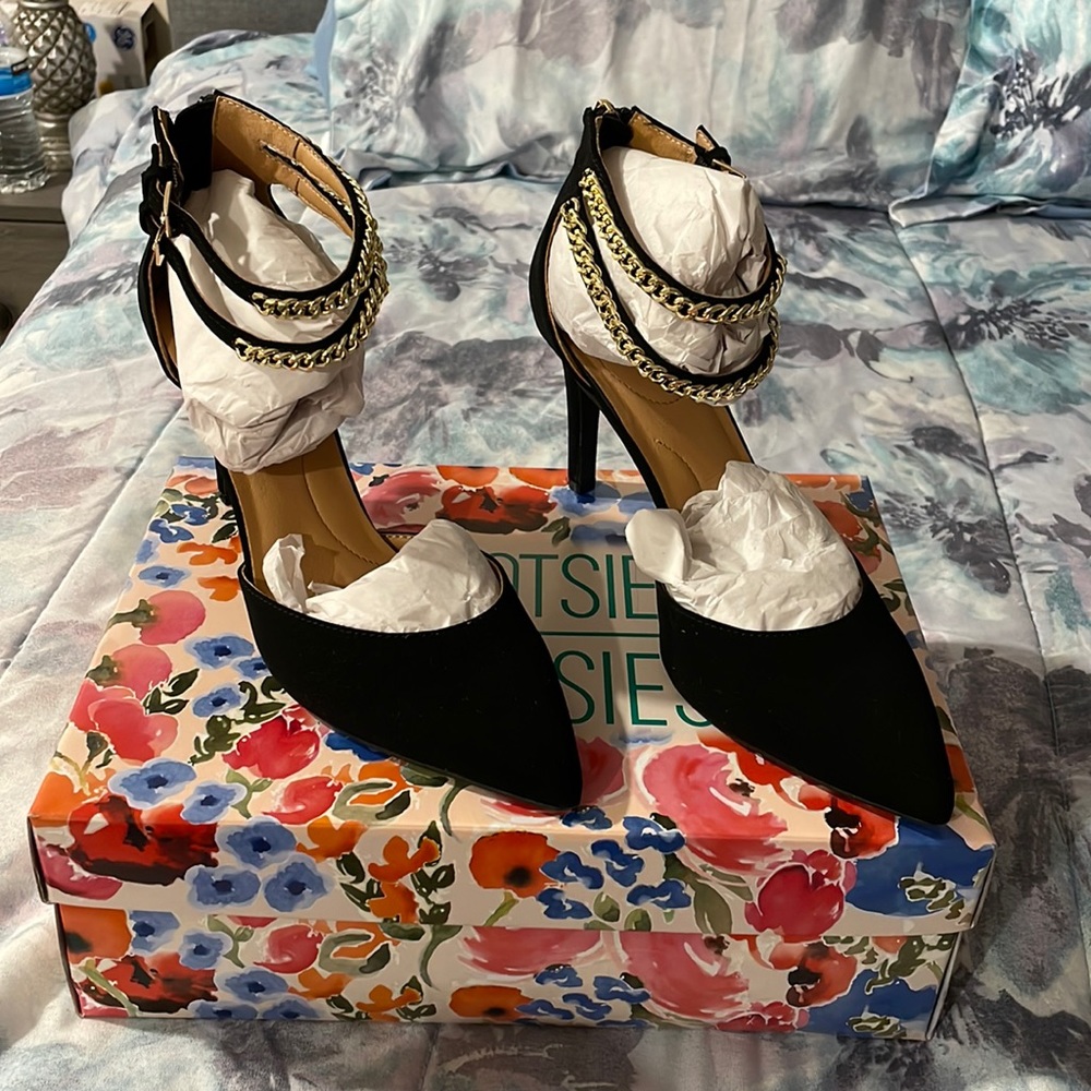 Black pointy heels with chain straps.